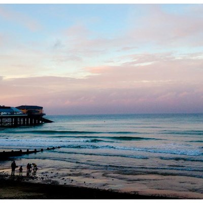 A family and 2 surfers enjoy the beautiful light & mid tide clean lines last night on dust....